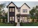 Charming two-story home featuring a stone facade, black framed windows and professionally landscaped front yard at 211 29Th Ave N, St Petersburg, FL 33704