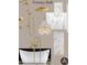 Elegant primary bath featuring soaking tub, gold fixtures, and chandelier at 211 29Th Ave N, St Petersburg, FL 33704