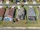 Aerial view of the back of the home with a screened pool and large backyard overlooking a lake at 27318 Sora Blvd, Wesley Chapel, FL 33544