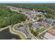Aerial view of the Quail Woods neighborhood featuring tree lined streets and community lake at 27318 Sora Blvd, Wesley Chapel, FL 33544