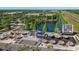 An aerial of The Grove shopping area with stores, open event space, and water feature, with highway and trees in the background at 27318 Sora Blvd, Wesley Chapel, FL 33544