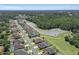 Wide aerial view of the Quail Woods neighborhood homes, ponds and wooded areas at 27318 Sora Blvd, Wesley Chapel, FL 33544