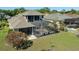 Aerial view of a home's backyard featuring an enclosed pool and a lush green lawn at 27318 Sora Blvd, Wesley Chapel, FL 33544