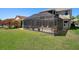 Backyard with expansive screened in patio and lush green lawn at 27318 Sora Blvd, Wesley Chapel, FL 33544