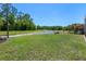 The home backs up to a pond and a grassy lawn at 27318 Sora Blvd, Wesley Chapel, FL 33544