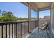 Balcony with two chairs and a calming view of a lake and mature trees at 27318 Sora Blvd, Wesley Chapel, FL 33544