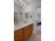Bathroom featuring double sinks and vanity and view into adjoining room at 27318 Sora Blvd, Wesley Chapel, FL 33544