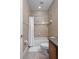 Cozy bathroom with shower/tub combo featuring tiled walls and a shower curtain at 27318 Sora Blvd, Wesley Chapel, FL 33544