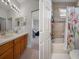Bathroom featuring double sinks and vanity plus combination tub/shower at 27318 Sora Blvd, Wesley Chapel, FL 33544
