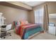 Cozy bedroom features a large window and colorful bedding at 27318 Sora Blvd, Wesley Chapel, FL 33544