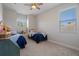 Well-lit bedroom featuring two twin beds, a window, and neutral carpeting at 27318 Sora Blvd, Wesley Chapel, FL 33544