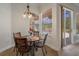Cozy breakfast nook with table and chairs, looks out to screened patio at 27318 Sora Blvd, Wesley Chapel, FL 33544