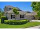 Attractive home exterior featuring a manicured lawn, stone accents, and a three-car garage at 27318 Sora Blvd, Wesley Chapel, FL 33544
