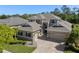 Beautiful two-story home showcasing a three-car garage and lush landscaping at 27318 Sora Blvd, Wesley Chapel, FL 33544