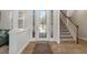 Inviting foyer with a decorative glass front door and staircase at 27318 Sora Blvd, Wesley Chapel, FL 33544