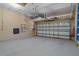 Spacious two car garage with overhead storage and garage door with decorative windows at 27318 Sora Blvd, Wesley Chapel, FL 33544