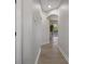Hallway with hardwood flooring and natural light streaming from a window at 27318 Sora Blvd, Wesley Chapel, FL 33544