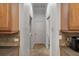 Hallway with lots of storage, doors, and neutral colored walls at 27318 Sora Blvd, Wesley Chapel, FL 33544