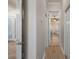 Hallway with wood floors and several doors leading to other rooms at 27318 Sora Blvd, Wesley Chapel, FL 33544