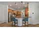 Modern kitchen features stainless steel appliances and breakfast bar seating at 27318 Sora Blvd, Wesley Chapel, FL 33544