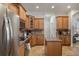Well-lit kitchen featuring stainless steel appliances and lots of wooden cabinets at 27318 Sora Blvd, Wesley Chapel, FL 33544