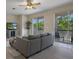 Open concept living room with hardwood flooring, ceiling fan, and balconies at 27318 Sora Blvd, Wesley Chapel, FL 33544