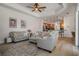 Spacious living room with elegant furniture and a seamless open floor plan at 27318 Sora Blvd, Wesley Chapel, FL 33544