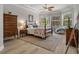 Large main bedroom with a ceiling fan, hardwood floors, and windows at 27318 Sora Blvd, Wesley Chapel, FL 33544
