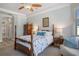 Stately main bedroom with a four poster bed and a ceiling fan at 27318 Sora Blvd, Wesley Chapel, FL 33544