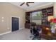Office features custom built-in bookshelves, crown molding, and a ceiling fan at 27318 Sora Blvd, Wesley Chapel, FL 33544