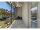 Enclosed patio with tile floors, ceiling fan, and access to the backyard and other rooms at 27318 Sora Blvd, Wesley Chapel, FL 33544