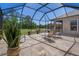 Covered patio with outdoor seating and views of the pond at 27318 Sora Blvd, Wesley Chapel, FL 33544