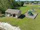 Community playground featuring a covered picnic area, swings, and a slide with mature trees at 27318 Sora Blvd, Wesley Chapel, FL 33544