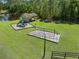 Community playground featuring a covered picnic area, swings, and a slide with mature trees at 27318 Sora Blvd, Wesley Chapel, FL 33544