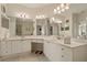 Large bathroom featuring dual sinks, white cabinets, and tiled floors, creating a clean and bright space at 2746 Via Tivoli # 135A, Clearwater, FL 33764