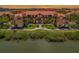 Beautiful waterfront condo building with well-manicured landscaping and lush tropical greenery at 2746 Via Tivoli # 135A, Clearwater, FL 33764
