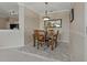 Cozy dining room with a chandelier, a decorative mirror, and seating for four people at 2746 Via Tivoli # 135A, Clearwater, FL 33764