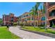 Condo building featuring mature landscaping, lush greenery, and sidewalks to each building at 2746 Via Tivoli # 135A, Clearwater, FL 33764