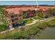 Beautiful multi-story condo building in desirable location with private balconies, lush green landscaping, and waterway views at 2746 Via Tivoli # 135A, Clearwater, FL 33764