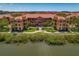 Stunning building exterior with lush landscaping, waterfront views and manicured walkways at 2746 Via Tivoli # 135A, Clearwater, FL 33764