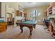A fun game room featuring a pool table, built-in shelving, decor, and views of the outdoors at 2746 Via Tivoli # 135A, Clearwater, FL 33764