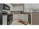 Well-equipped kitchen with stainless steel appliances, granite countertops, and sleek white cabinetry at 2746 Via Tivoli # 135A, Clearwater, FL 33764