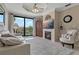 Cozy living room with a fireplace and balcony access that offers stunning waterfront views and natural light at 2746 Via Tivoli # 135A, Clearwater, FL 33764