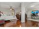 Spacious main bedroom with hardwood floors, ceiling fan, and adjacent home office at 2746 Via Tivoli # 135A, Clearwater, FL 33764