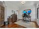 Well-lit home office with hardwood floors, built-in storage, and a practical workstation setup at 2746 Via Tivoli # 135A, Clearwater, FL 33764