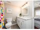 Bathroom with white cabinets, granite counters, a toilet, and a colorful shower curtain at 320 Island Way # 606, Clearwater Beach, FL 33767