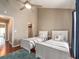 Bedroom features two beds, hardwood floors, ensuite bath and ceiling fan at 320 Island Way # 606, Clearwater Beach, FL 33767