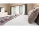 King-sized bed with decorative towels and balcony access through sliding glass doors at 320 Island Way # 606, Clearwater Beach, FL 33767