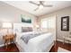 Cozy bedroom with ceiling fan and a king-sized bed featuring decorative swans made from towels at 320 Island Way # 606, Clearwater Beach, FL 33767
