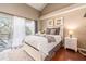 Bedroom with balcony access featuring king sized bed with decorative towels and ceiling fan at 320 Island Way # 606, Clearwater Beach, FL 33767